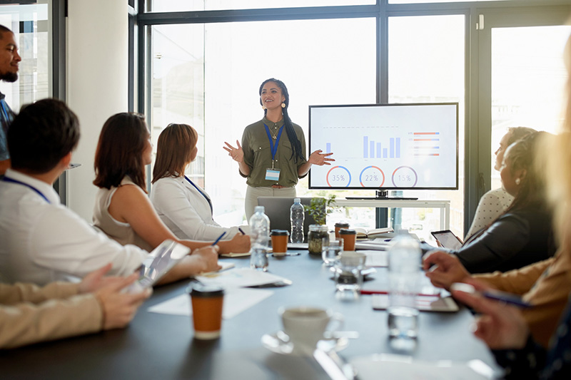 Worker collaborating in a meeting-695810036 Workers collaborating in a meeting