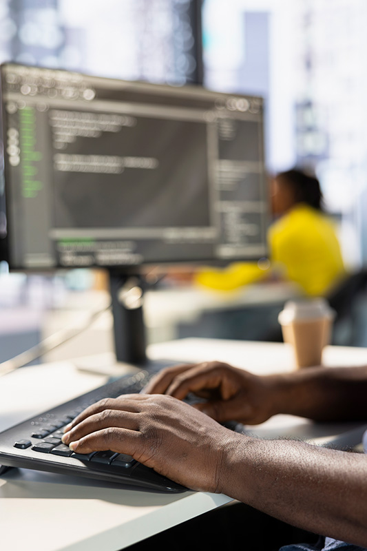 Programmer typing on keyboard, developing software Programmer typing on keyboard, developing software